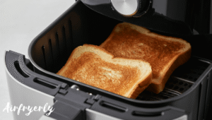 A slice of white bread placed in an air fryer basket, lightly golden and toasting evenly.
