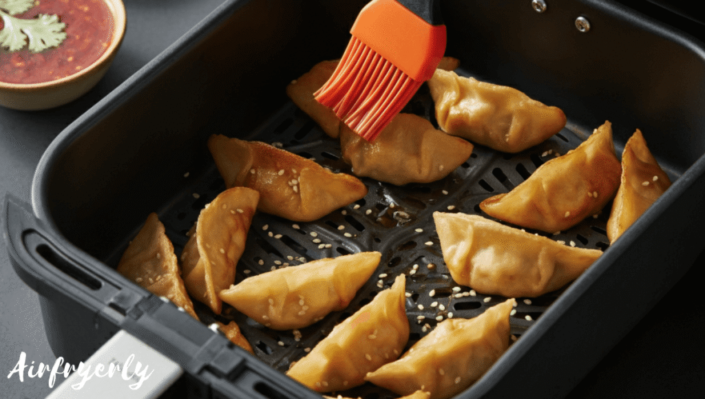 Frozen Tai Pei potstickers being brushed with oil before air frying