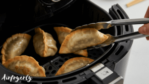 Tai Pei potstickers cooking in air fryer basket at 375°F