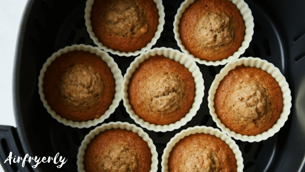 Golden banana muffins baking in air fryer at 320°F for 15 minutes
