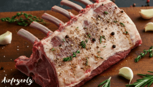 Lamb rack fully coated with olive oil, crushed garlic, rosemary, thyme, salt, and pepper before air frying.