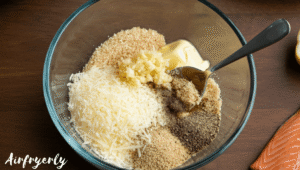 Bowl of mixed Parmesan, breadcrumbs, garlic, butter, and spices forming a crumbly coating