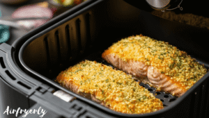 Crusted salmon fillets placed skin-side down in air fryer basket before cooking