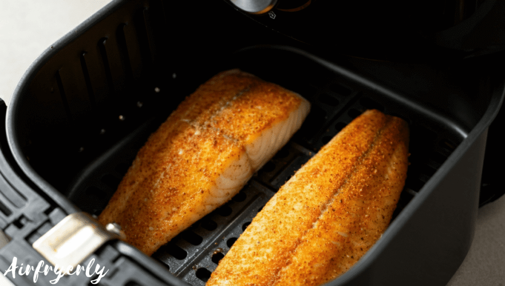 Grouper fillets cooking inside air fryer at 400°F
