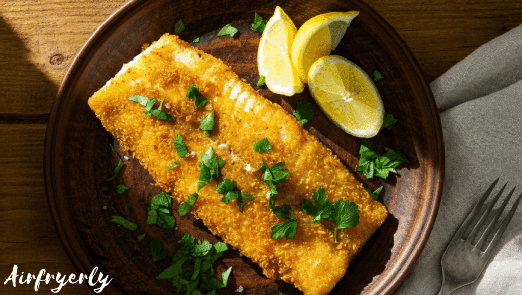 Crispy golden grouper fillets served with lemon wedges and herbs, cooked in air fryer