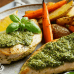 Juicy chicken pesto air fryer dish served on a plate, garnished with herbs and paired with roasted veggies on the side – perfect for a quick weeknight dinner