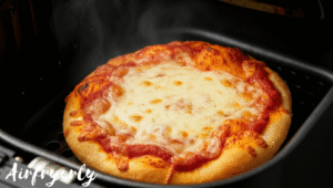 Mini pizza cooking in air fryer with cheese bubbling and edges turning golden brown