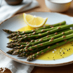 "Golden and crispy frozen asparagus in air fryer basket, cooked to perfection with a light char, bright kitchen lighting, healthy side dish."