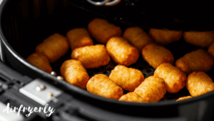 Golden crispy Ore Ida tater tots in air fryer basket after cooking to perfection